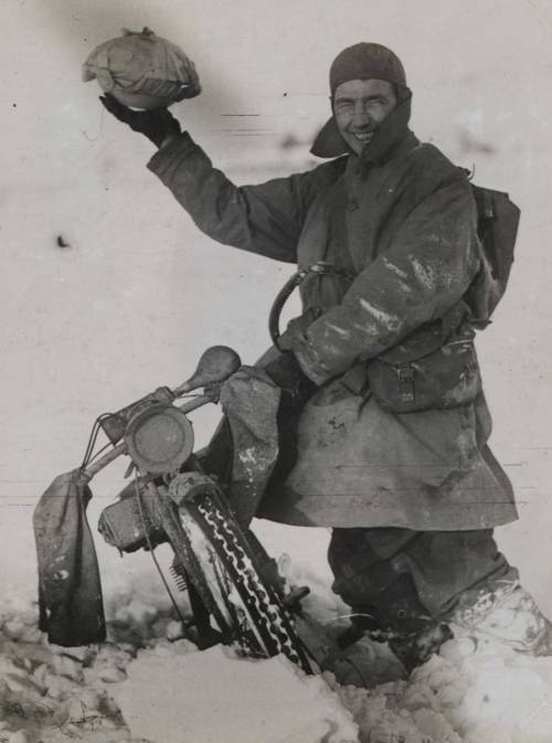 thedeadofflandersfields:A pudding is held aloft by a grinning motorcyclist with the British Royal En
