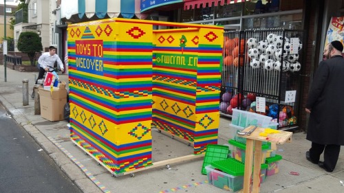 happiness-in-yiddish: Amazing sukkah made out of Lego in boro park in front of a toy store.
