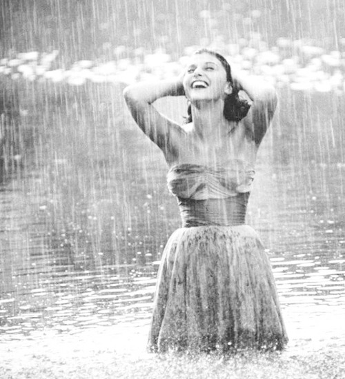 missavagardner:   Pier Angeli, 22, clad in strapless chiffon party dress, exhulting in a downpour of