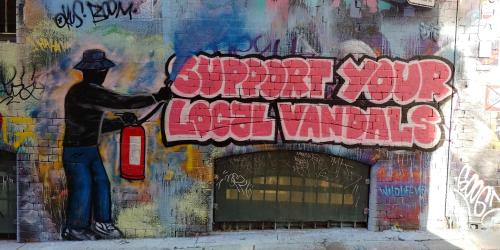 ‘Support Your Local Vandals’ mural in Hosier Lane, Melbourne. The painting refers to an 
