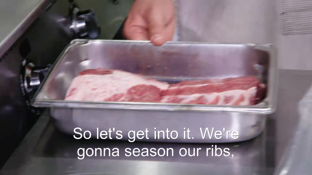 73% sure it's a person cooking food on a tray. Caption: So let's get into it. We're gonna season our ribs,