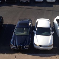 weallheartonedirection:  What to do when a Jaguar parks over two spots, at the front, in a busy lot. White Nissan is me. OC