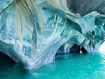 The marble caverns of Cathedral de Mármol Caverns of white and black swirled rock rise out of