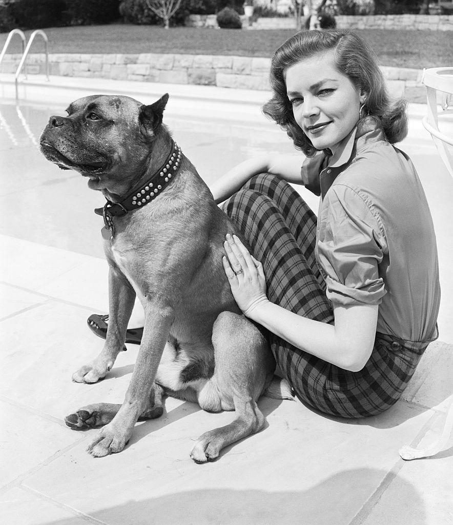 Lauren Bacall at home with her dog, 1955.