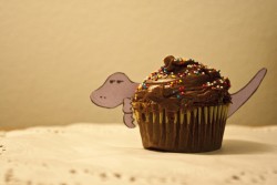 Tiny dinosaur eating a cupcake makes me happy
