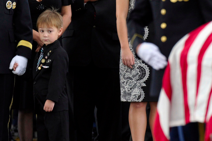 Kaden Bowden, son of U.S. Army Staff Sgt. Joshua J. Bowden, looks at the casket for his father during burial services for Staff Sgt. Bowden at Arlington National Cemetery in Arlington, Va (Photo by Susan Walsh/AP via LightBox)