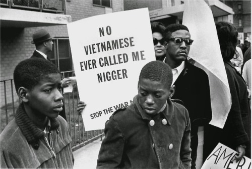 A demonstrator at the Harlem Peace March to end racial oppression, carrying an anti-war sign (1967).