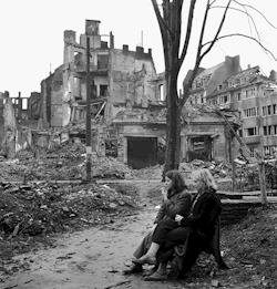 flashofgod: Lee Miller, Two German women sitting on a park bench surrounded by destroyed buildings, Cologne, Germany, 1945.