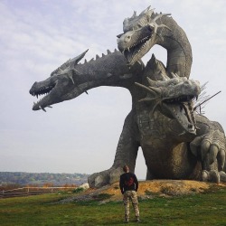 sixpenceee:A three-headed dragon statue in