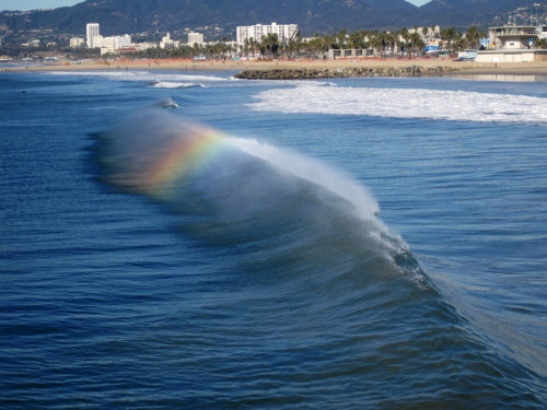 kenobi-wan-obi:  Ocean Wave Rainbows  When a beam of sunlight comes down to Earth, the light is white. But, if the light beam happens to hit raindrops (in the above scenario mist from the ocean waves) on the way down at a certain angle, the different