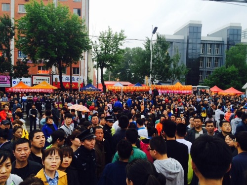 Parents trying to patiently wait for their children as they come out of the first day of Gaokao, the