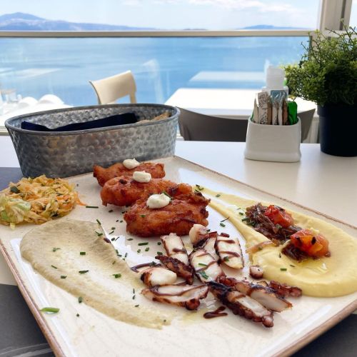 Appetizer trilogy with tomato fritters, fava, grilled octopus, tartar sauce, finocchio sauce.  Oia, 