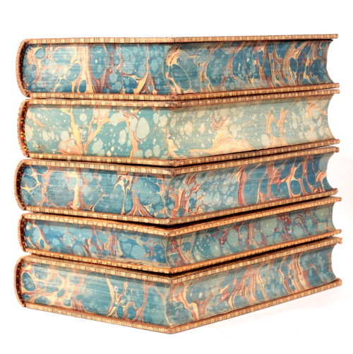 Fine leather bound books with gilt tooling and marbled page edges..