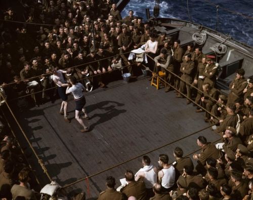 mpdrolet:  British soldiers watching a boxing match on a troop ship traveling from England to North Africa, 1943 Robert Capa