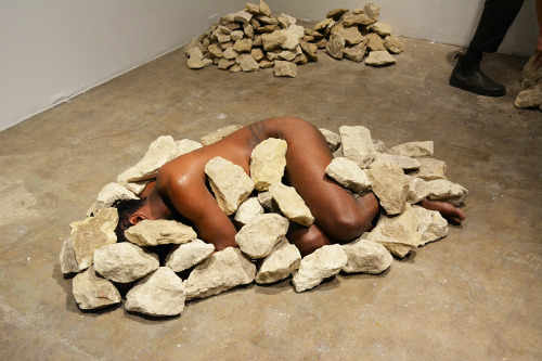 janemba:  theletteryogh:  colorthefuture:  Ruins (2015), Carlos MartielI lay in the fetal position naked on the floor of the gallery, two Caucasian men covered me with rocks until my body became invisible.  is this art?If so, I don’t get it  Well you’re