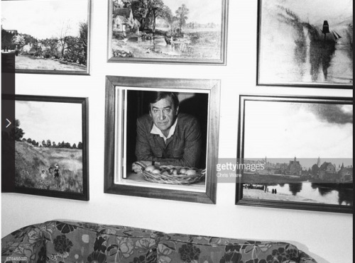 tipsywench:This photo of Patrick Troughton peeking through the framed hole (why?) in his living room