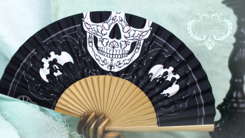 A folding fan. If you peek over the top, it looks like the skull is the lower part of your face. I d