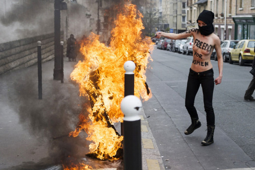 fohk:  A Femen activist burns a Salafist flag in front of the Great Mosque of Paris, on April 3, 2013 source 