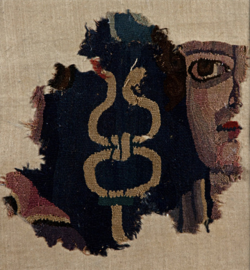 mostly-history:Textile painting of a male face and a cadeuceus (Loulan, China, 200 –400 AD).  A cade