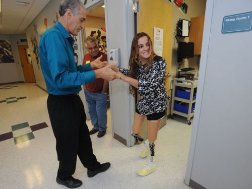 Yellow converses (?) on prosthetic legs of DAK amputee girl