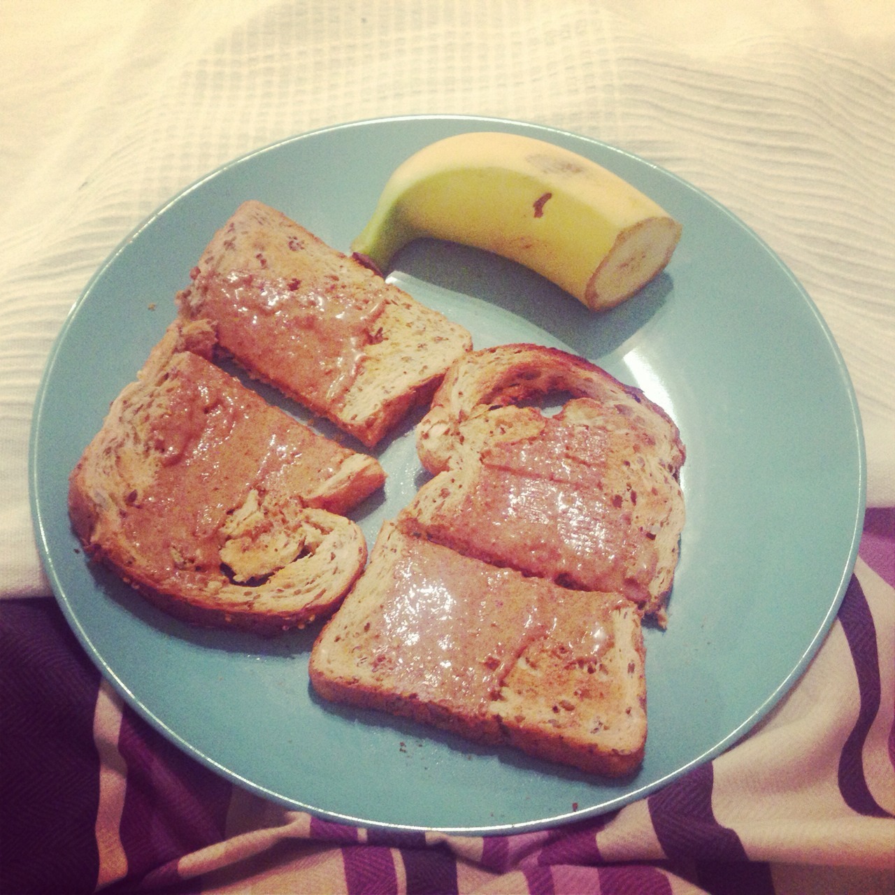 A great pre workout breakfast. Natural peanut butter on toast and half a banana.