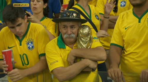 Trivia from the “sad guy with a mythical moustache holding the World Cup trophy”, and some happy pictures of him! His name is Clovis Acosta Fernandes, also known as “Gaúcho da Copa”. He’s 59 years old and works as a real