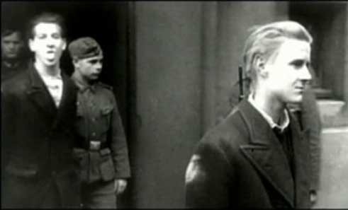  Young communist resistant Jean Quarré, pulling faces to the German cameraman while being taken to the firing squad. France, 1944. 