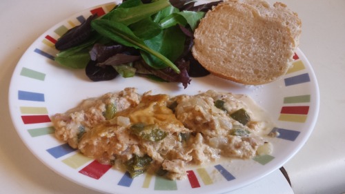 a plate featuring salmon casserole. The liquid from the casserole runs across the plate.