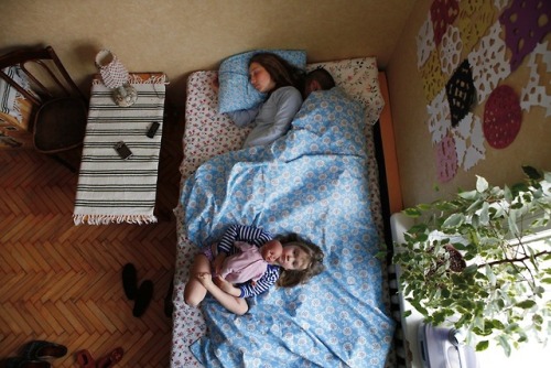  Jana Romanova a Russian photographer captures couples in their sleep to explore their cultural attitude inside their families. Since she didn’t want them to pose she had to stick around their house till they fall asleep deeply and she would take the