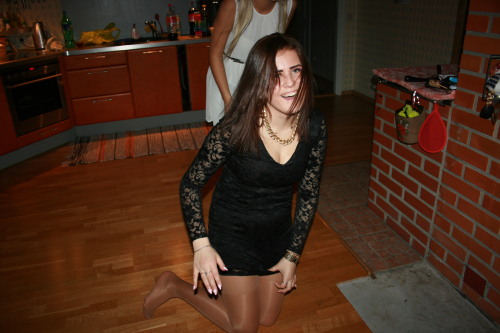 Lovely girl in tan reinforced pantyhose and tight lacy dress.Woman in pantyhose