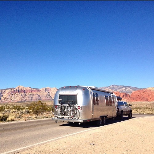 meanwhileinvegas:Cheers to one of the best roadtrips to date. 5 states. 4 homies. 3 showers. 2 tradeshows. 1 rad airstream. by joshdeiss http://ift.tt/17WUzdZ  Red Rock in the back ground.