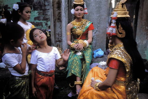global-musings:Members of a Cambodian classical dance troupe dress and prepare for a perfomance in t