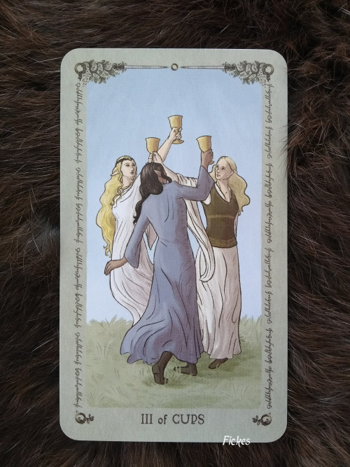 Lord of the Rings Tarot: III of Cups: The women of Middle-earth celebrate their sisterhood[ID: a pho