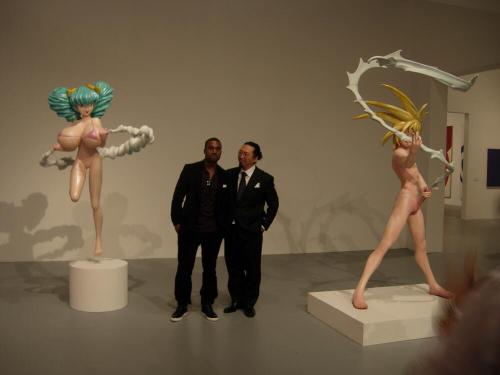 voodoobrown:this is not photoshopped. this is an actual, real life picture of kanye west, takashi murakami, and two of his hentai sculptures. this is a real event that actually took place