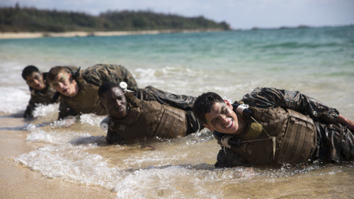 ceebee23: Okinawa, Japan - Marines work together to perform squad sit-ups in the waves of Kin Blue, 