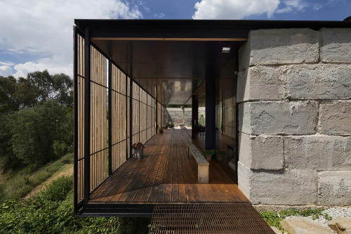 cjwho:  SawMill House, Australia by Archier Studio |via  From the architect: The Sawmill House uses large reclaimed one tonne blocks of reclaimed concrete which anchor it into the landscape and a dynamic active building envelope to regulate the internal