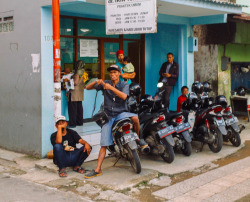  People hanging out outside of a doctor&rsquo;s office. Bandung, Indonesia.  