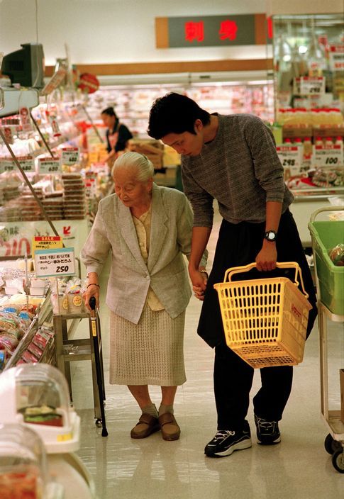 unearthedviews: JAPAN. Okinawa Island. Nara City. 100 year old Ms. Fumi shopping in a supermarket wi