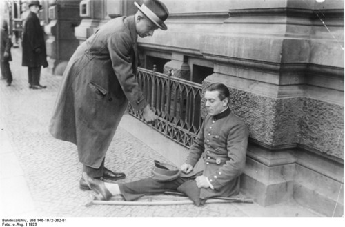 A First World War veteran begs on the streets of postwar Germany in 1923. As the Weimar hyperinflati