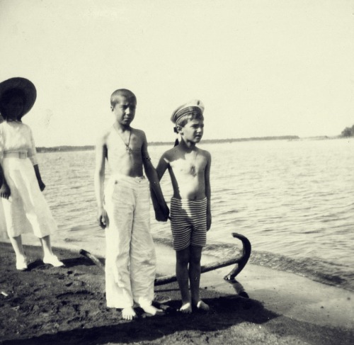 Tsarevich Alexei with a friend.Grand Duchess Maria is in the background.