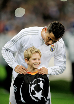 madridistaforever:  Cristiano Ronaldo jokes with a player escort during the UEFA Champions League Group A match between Real Madrid and Paris Saint-Germain | November 3, 2015