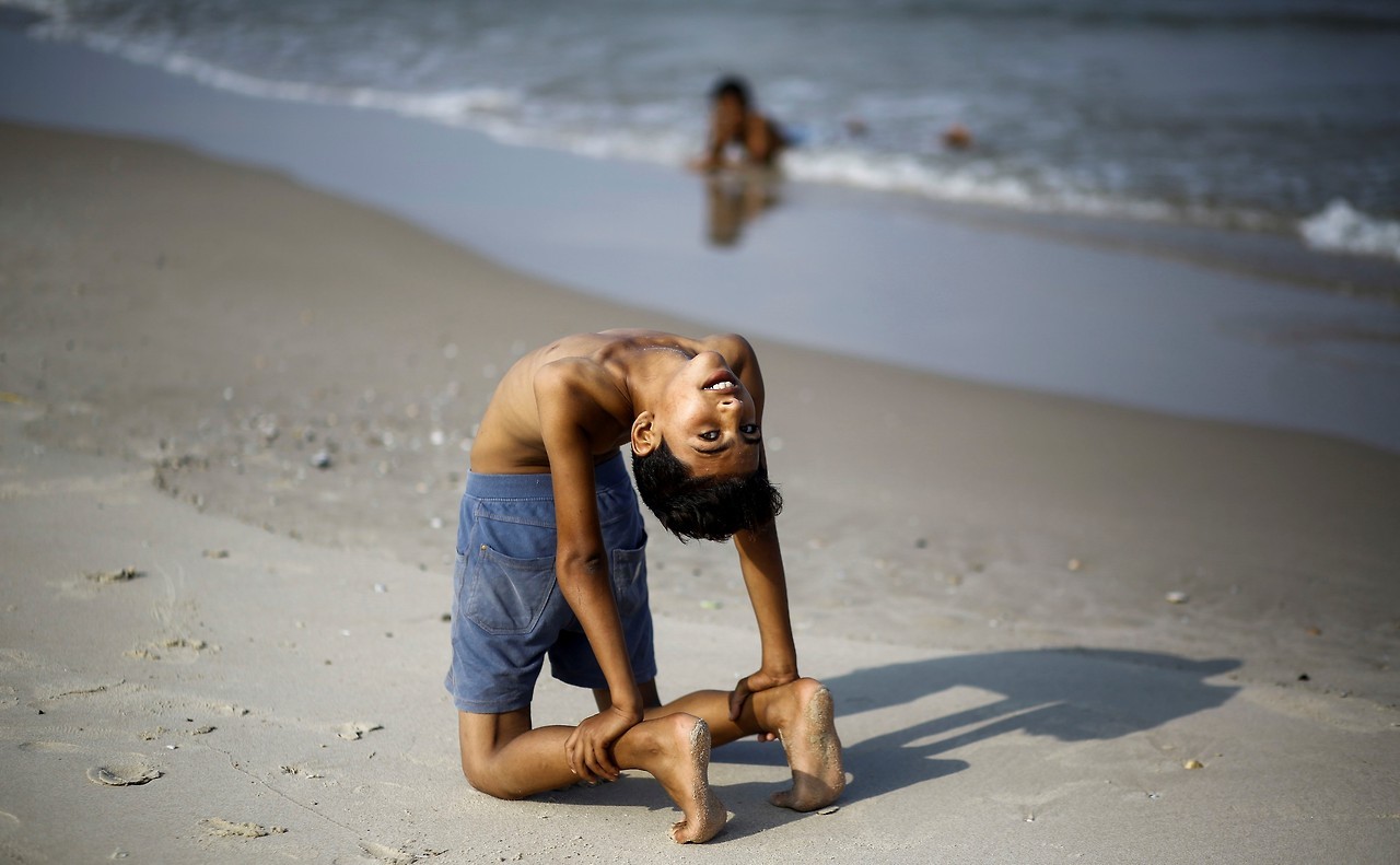 RECORD. Yousef Al-Bahtini, un niño palestino de doce años de edad, invitado por ‘Guiness World Records’ por caminar 20 metros con el cuerpo contorsionado, muestra sus habilidades acrobáticas mientras contorsiona su cuerpo en el puerto de Gaza....