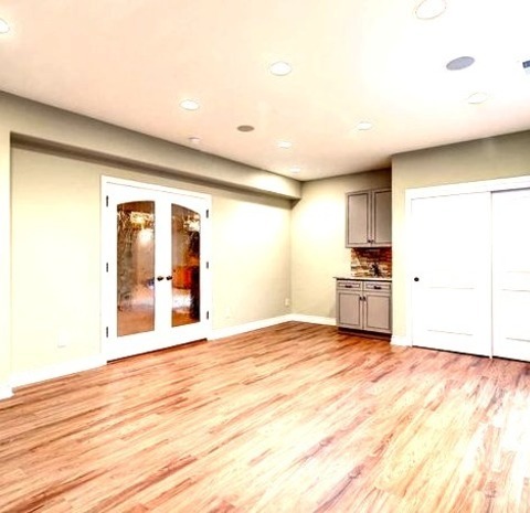 Contemporary BasementMid-sized Trendy Walk-out Ceramic Tile And Beige Floor Basement Photo With Beige
