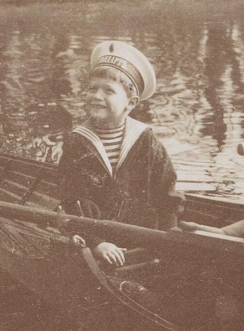 A smiling little Tsarevich Alexei Nikolaevich Romanov.