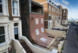 itscolossal:  A Brick Facade Appears to Melt Off of an Apartment Building in Margate 