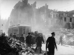 historicaltimes: A scene of life in a bombed-out city - Civilians, soldiers, a priest and a tram among ruined buildings in Milan, Italy, 1943 via reddit 