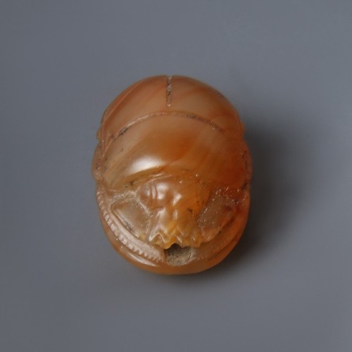 Carnelian Scarab AmuletA beautiful Egyptian scarab amulet made in bright carnelian. The front depict
