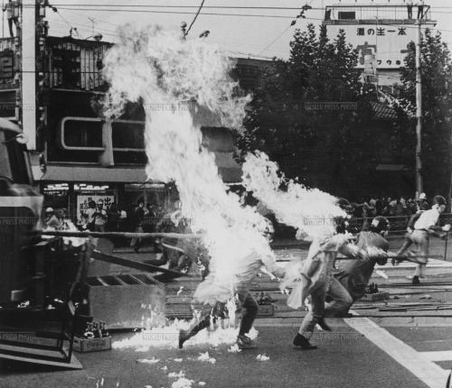 Students are burnt by a petrol bomb during street fights. Year: 1969 Photographer: Toshio Aoi P