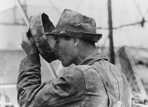 Oil field worker drinking water from a crude metal container, Kilgore, Texas. 1939Russell Lee