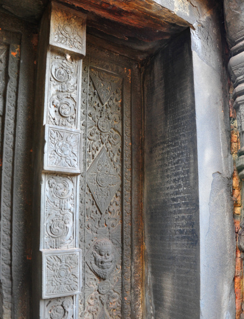 A false door on one of the Preah Ko towers, Cambodia. Writing is chiseled into the tower doorways, a